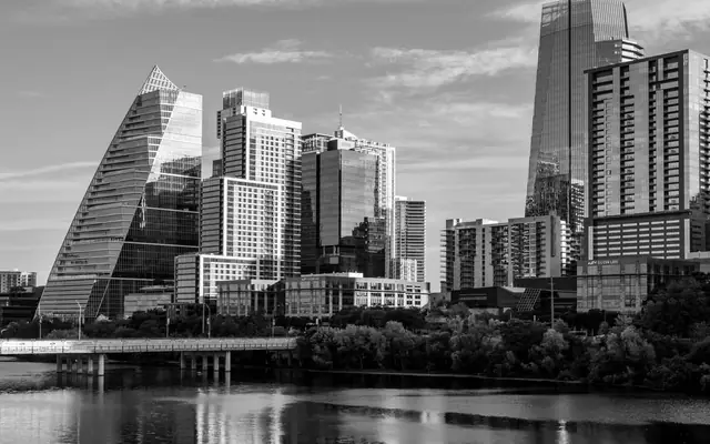 Black and white view of Austin's modern skyline with reflections on water.