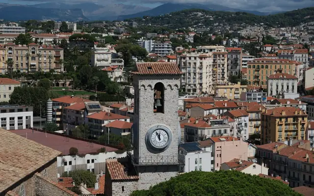 A stunning aerial view of the iconic clock tower amidst the vibrant cityscape of Cannes, France.