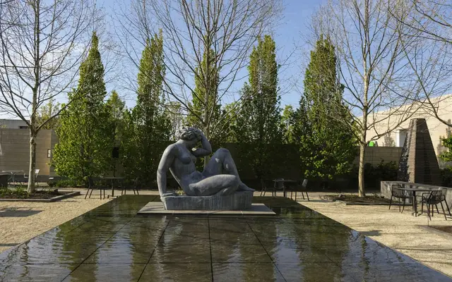Peaceful garden with a sculptural statue in Columbus, Ohio, showcasing serene landscape design.