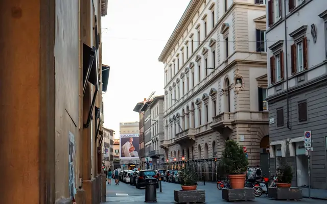 Picturesque street in Florence, Italy with classic architecture and vibrant city life.