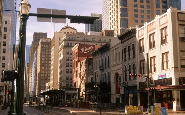 Charming street view of downtown Houston with historic buildings on a sunny day.