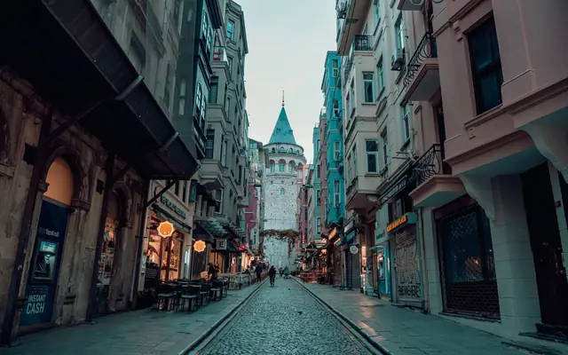 A picturesque view of a bustling street leading to the iconic Galata Tower in Istanbul.