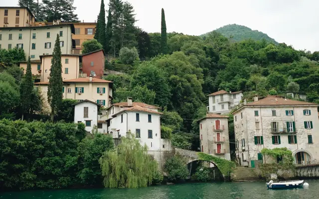 Picturesque lakeside villas surrounded by lush greenery on Lake Como, Italy.