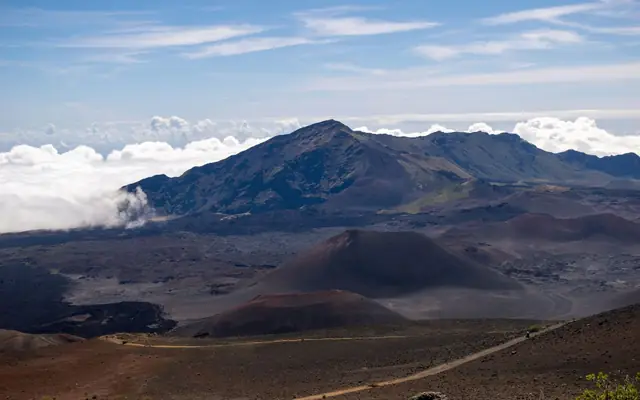 Breathtaking view of the Haleakalā volcano crater under a clear blue sky in Maui, Hawaii.