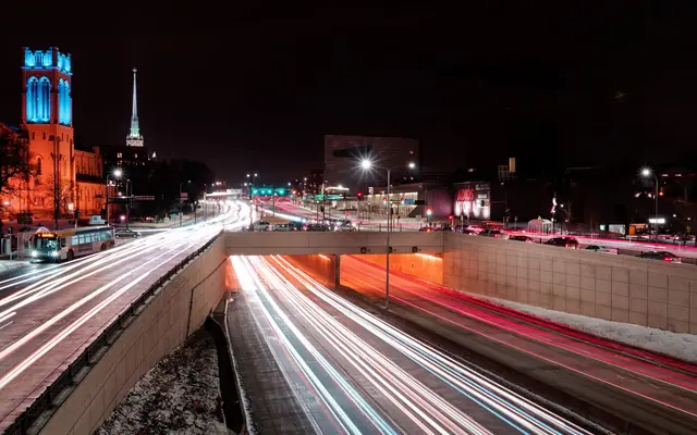 Dynamic long-exposure shot of illuminated city streets in Minneapolis at night.