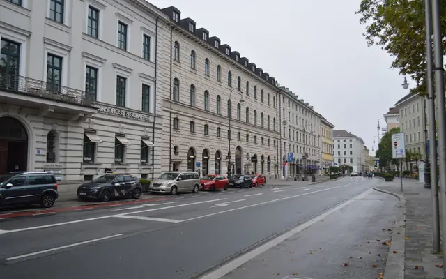 An empty street in Munich showcasing classic European architecture on an overcast day.