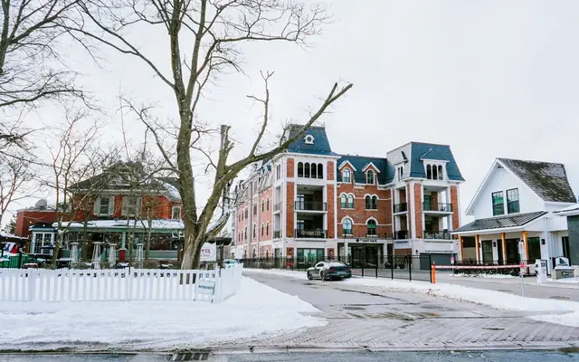 A picturesque snowy scene featuring historic buildings and a serene urban street in winter.