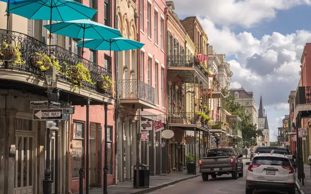 Explore the vibrant architecture and lively streets of the French Quarter in New Orleans, captured in rich detail.