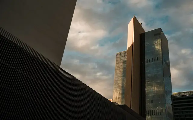 Tall skyscrapers in downtown Phoenix reflecting the sunset sky, showcasing modern architecture.