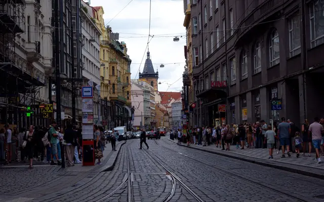 Explore the bustling streets of Prague with tram lines and historic architecture in this urban snapshot.