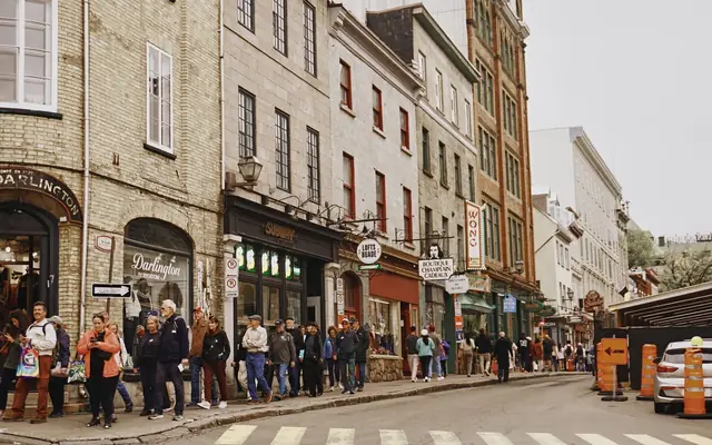 Vibrant street view of Old Quebec, featuring bustling pedestrians and historic architecture.