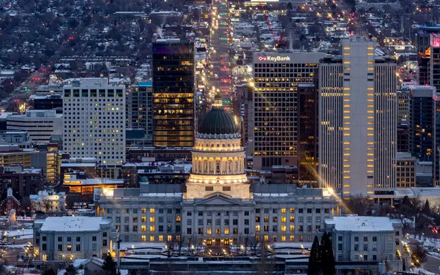 A breathtaking view of Salt Lake City's skyline illuminated at night, featuring the Utah State Capitol.