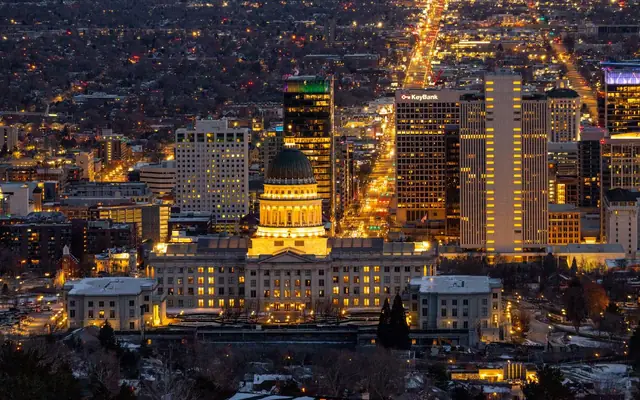 Stunning aerial view of Salt Lake City skyline featuring the Utah State Capitol illuminated at night.