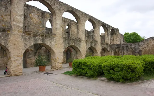 Explore the historic arched stone facade at San Antonio Missions National Historical Park.
