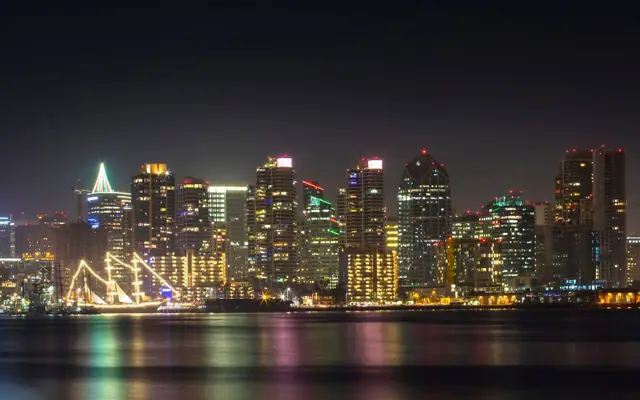 Stunning view of San Diego's illuminated skyline reflecting on the water at night.