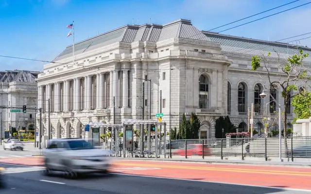 Elegant historic architecture photographed in San Francisco's Civic Center, capturing urban movement.