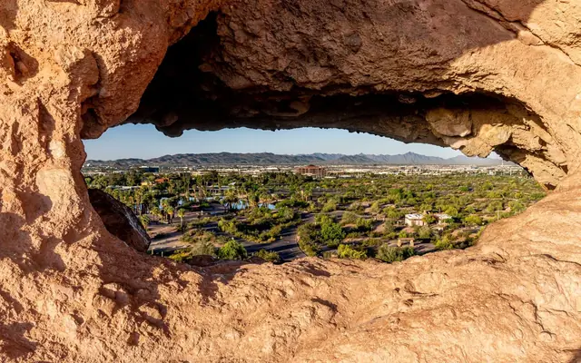 Capture of Phoenix cityscape through a unique rock formation in Papago Park, Arizona.