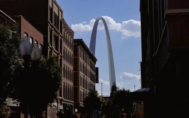 The iconic Gateway Arch rises between city buildings in St. Louis, USA.