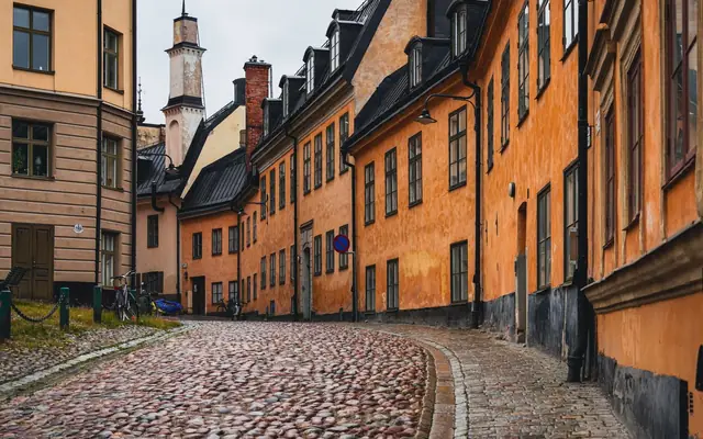 Beautiful narrow street lined with colorful historic buildings in Gamla Stan, Stockholm.
