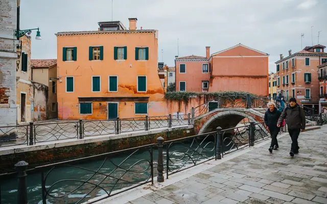 A picturesque scene of Venice with colorful buildings lining a serene canal, showcasing its unique architecture.
