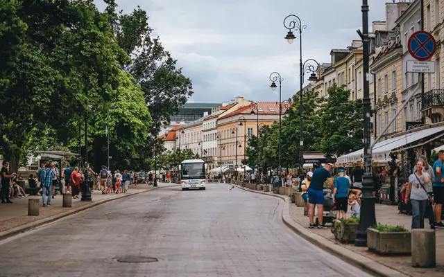 Dynamic city street scene in Warsaw, showcasing architecture and daily life.