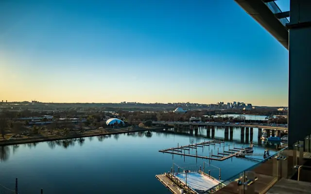 A breathtaking view of Washington DC's waterfront with clear skies and cityscape at sunset.