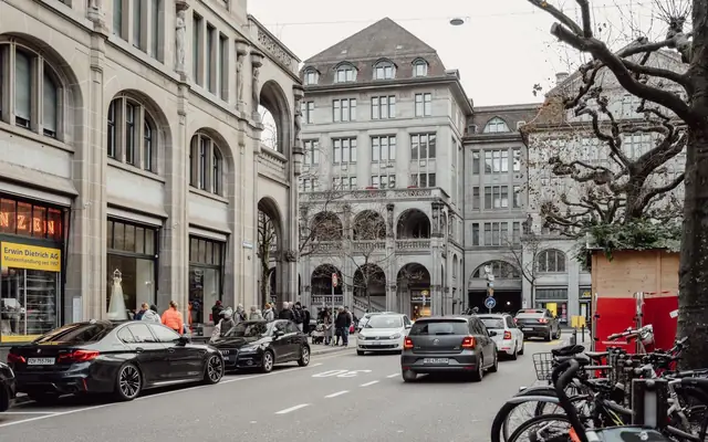 Explore the vibrant street life and historic architecture of Zurich, Switzerland in this captivating photo.