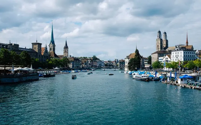 Explore Zurich's picturesque skyline along the Limmat River, capturing the urban charm and historic towers.